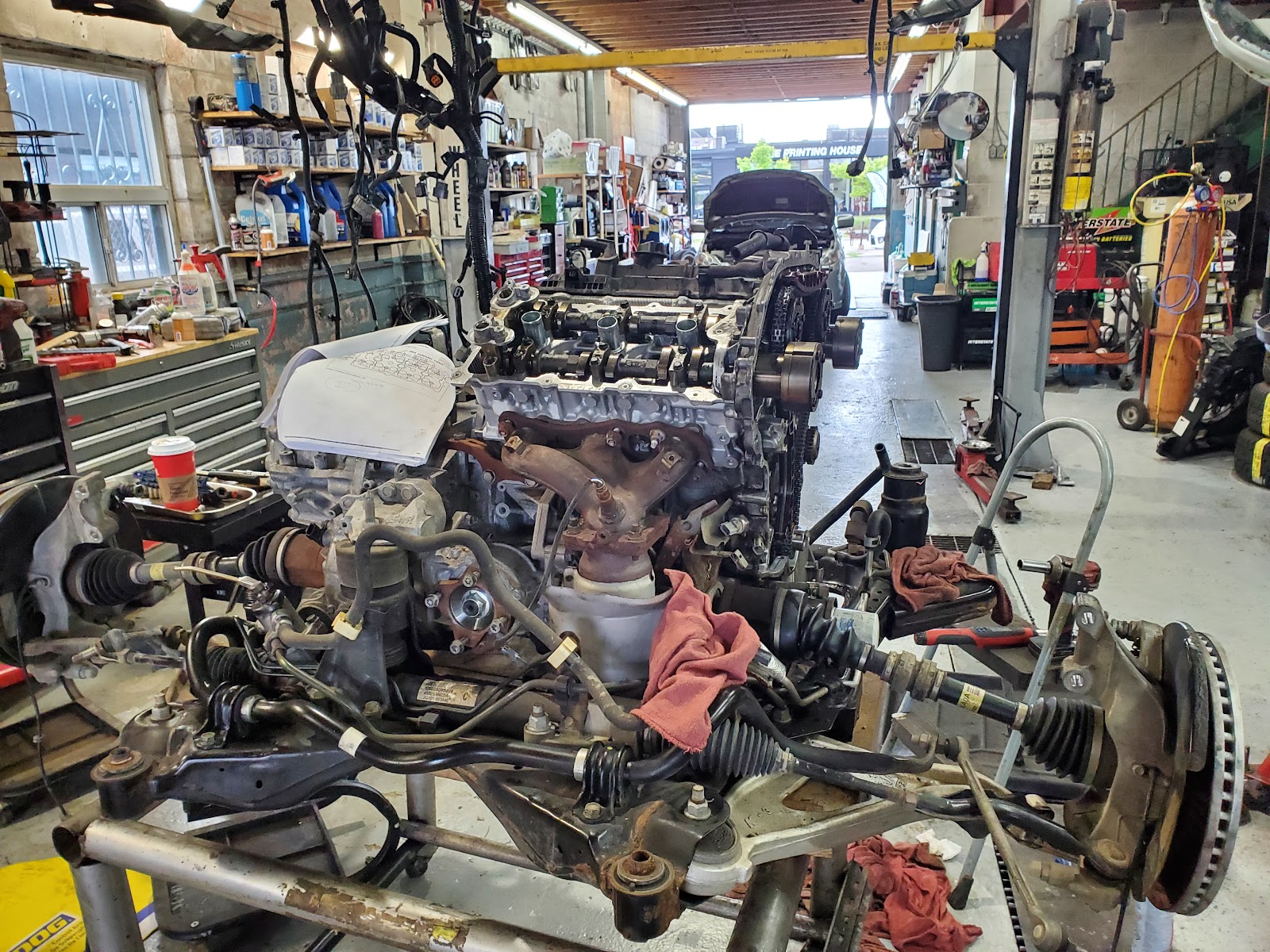 Engine on the floor inside the SM Auto Repair workshop